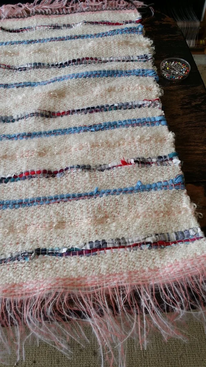 The baby rug reweaved from a deceased father’s clothing of a pregnant woman.