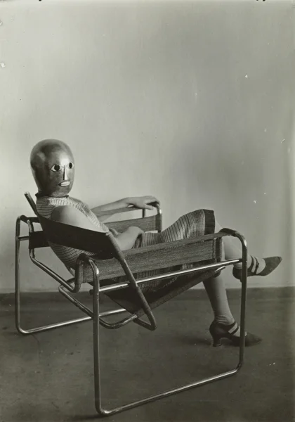 Woman in club chair (model B3)  Erich Consemüller (Lis Beyer or Ise Gropius seated in the chair) Marcel Breuer designed Mask by Oskar Schlemmer, dress by Lis Beyer © Stephan Consemüller; Klassik Stiftung Weimar, Donation Wulf Herzogenrath, Berlin