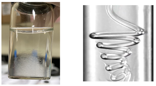 Left: Approximately 5,000 microfibers are collected in the container. Right: Coiling of a nonuniform microfiber with axially varied elastic modulus. As the fiber coils in the microfluidic device, it forms a spiral with a varying coiling radius that reflects the local elastic modulus. The higher the local elastic modulus, the larger the coiling radius of that segment. (Pictures are reproduced under the terms of the CC-BY license.) [Proc. Natl. Acad. Sci. U.S.A. 121, e2303679121, 2024]
