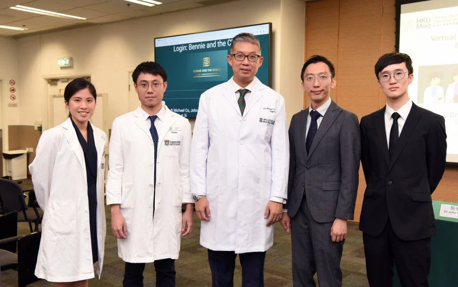 Dr Michael Co Tiong-hong (middle) and Dr John Yuen Tsz-hon (second right) along with their students, showcasing the novel 'AI virtual patients' diagnostic application which breaks spatial and geographical barriers.  