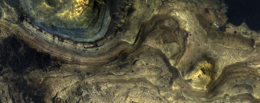 The blue-toned rocks in the upper-left of the image are depleted in iron because it was removed during weathering on ancient Mars. This is geological evidence that iron was lost from the rocks in reduced conditions.  