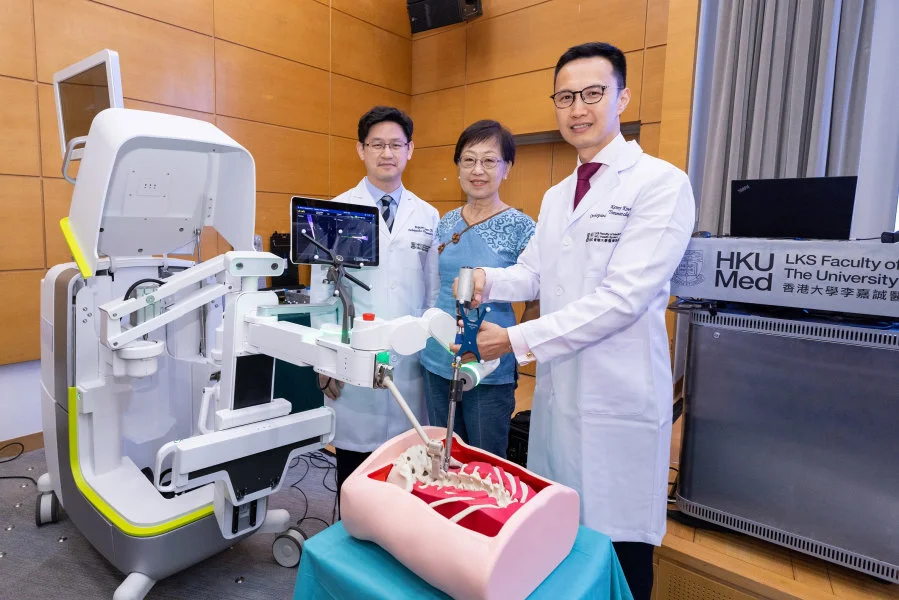 The use of robotic technology in spine surgery provides unprecedented precision. (From left) Professor Jason Cheung Pui-yin, Ms Lau who underwent robot-assisted spine surgery in October 2023, and Dr Kenny Kwan Yat-hong.  