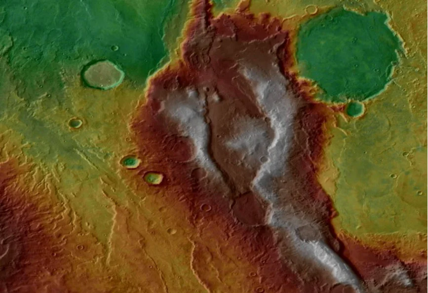 Figure 1. Topographic data are draped over infrared image data showing complex tectonic structures and volcanic deposits in the Eridania region of Mars. Warm colours are higher elevation. Image Credit: NASA/Mars Odyssey/HRSC.  