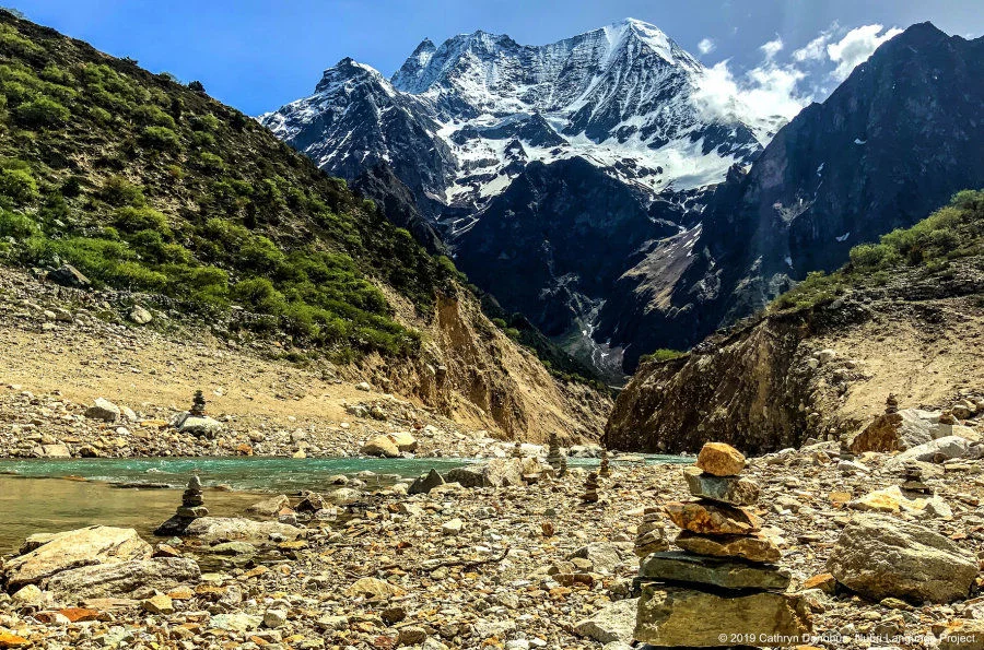 Many little piles of rocks, or chörten, can be seen by the shores of Birendra lake. Constructed by visitors to honour their loved ones. Their shape resembles that of the stupas, so prominent in Buddhist architecture.  