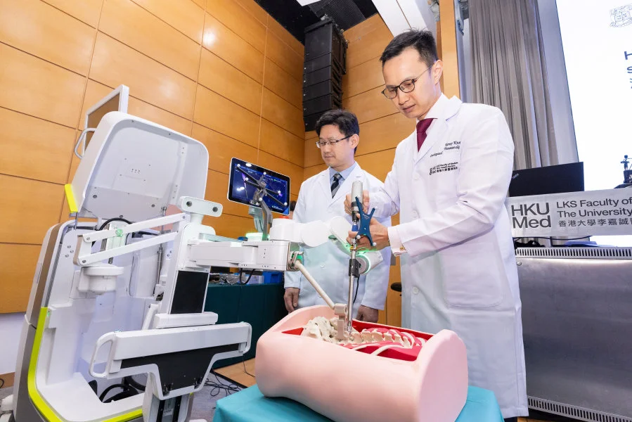 Dr Kenny Kwan Yat-hong (right) demonstrates the robot-assisted spine surgery.    