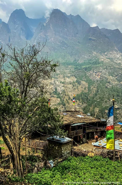 A row of typical houses, built as a single room (cooking, eating, sleeping) with a barn underneath. There is no running water in the homes, or electricity. Wires that are the start of the necessary infrastructure can be seen, but construction was halted after the 2015 Nepal earthquakes, the first and largest of which was centered to the immediate south, in Gorkha, and devastated much of the valley.  