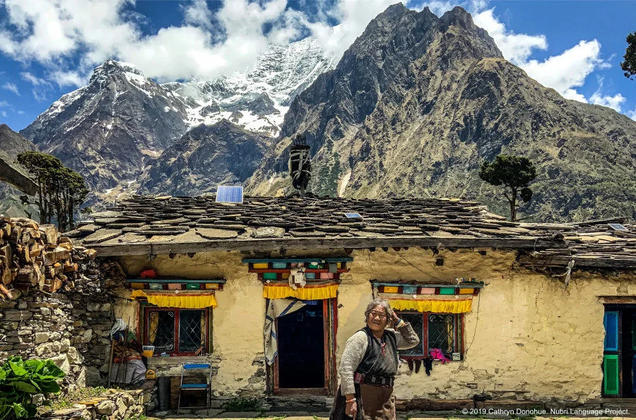 This home is attached to a small monastery in Sama, so it is more carefully constructed and more colourful. Houses are constructed from tightly piled stones but this home has been insulated by a coating of yak dung and paint. The monk’s wife stands in front.  