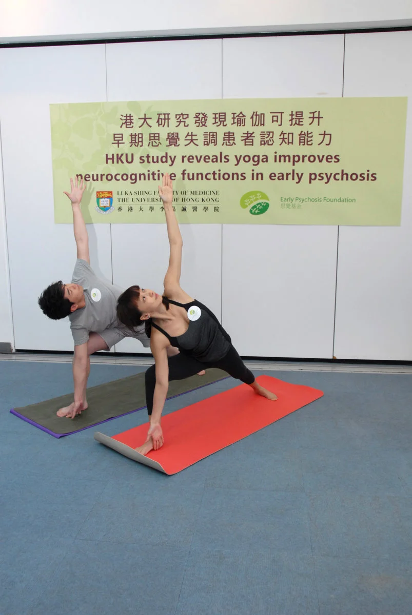 From the left:  Yoga student Andy Lin and yoga teacher Kiki Lin are demonstrating step-16, the “side angle pose”.