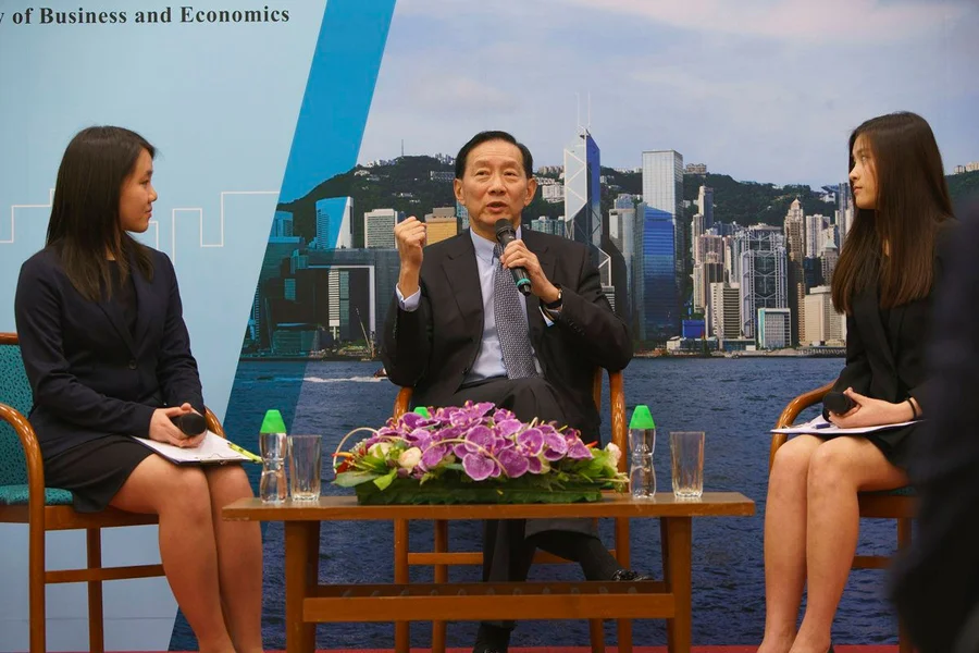 Mr. Peter Wong Tung Shun answers audience’s questions in a Q&A session moderated by two Student Ambassadors: Miss Christy Yeung, Year 2 Bachelor of Economics and Finance student (left) and Miss Ann Ko, final year students of Bachelor of Business Administration in Accounting and Finance (right).