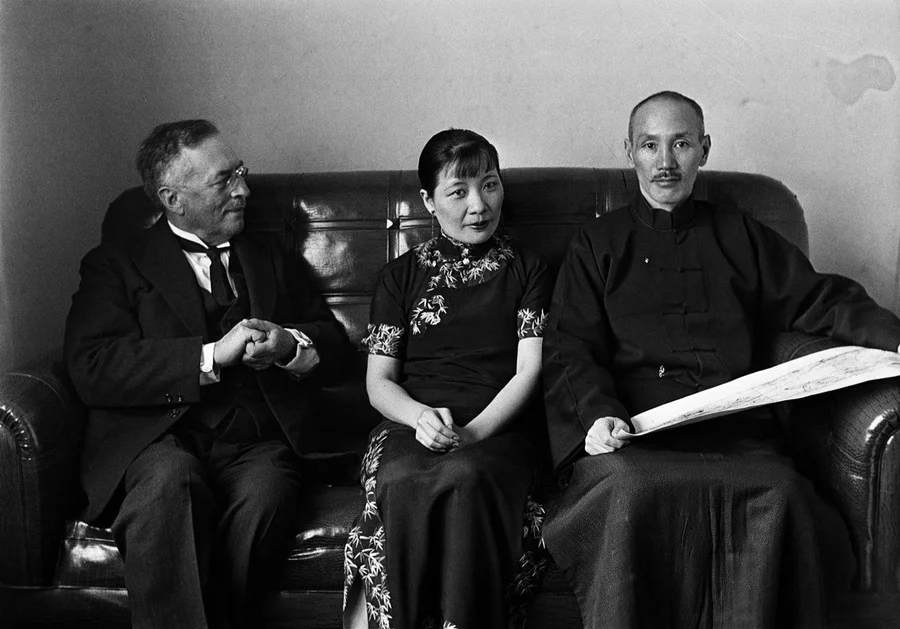 The Generalissimo and Mrs Chiang Kai-shek listening to Dr Sven Hedin speak about his journey to Sinkiang.